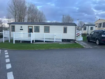 a white mobile home with a porch and a driveway at Luxury 6 Berth Caravan, Marton Mere in Blackpool
