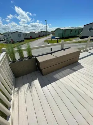 a bench on top of a roof with houses in the background at LA07 Oceanview in Morecambe