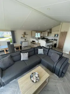 a living room with a couch and a kitchen at LA07 Oceanview in Morecambe