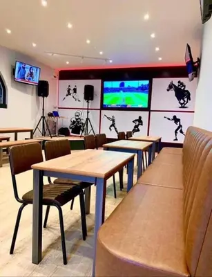 a dining room with tables and chairs and televisions at LA07 Oceanview in Morecambe