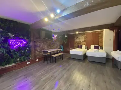 a room with two beds and a table in it at Rainford Gardens by UStay Aparthotels in Liverpool