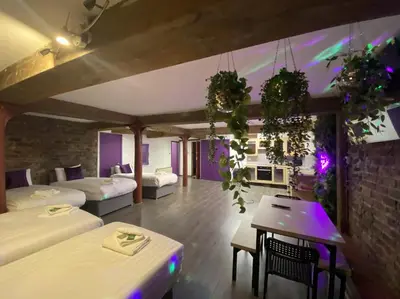 a room with two beds and a table in it at Rainford Gardens by UStay Aparthotels in Liverpool