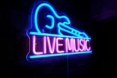 a neon sign that says live pause on a wall at Button Street by UStay Aparthotels in Liverpool
