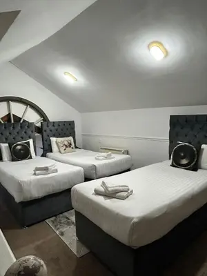 a room with three beds in a room at Button Street by UStay Aparthotels in Liverpool