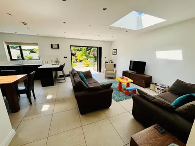 a living room with couches and a dining room at Hodder Cottage in The Ribble Valley in Whalley