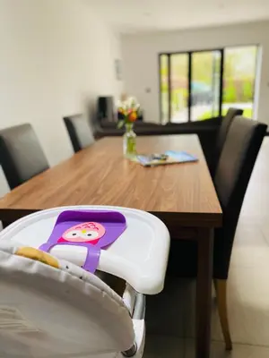 a dining room table with a hello kitty plate on a chair at Ribble Cottage in The Ribble Valley in Whalley
