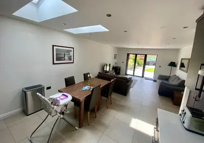 a living room with a table and a couch at Ribble Cottage in The Ribble Valley in Whalley