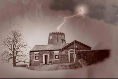 an old house with a tower with lightning in the sky at 'Mill Cottage' Parbold in Parbold