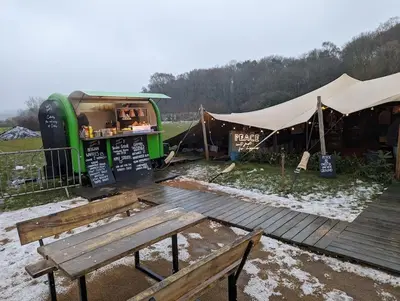 a food stand with a bench and a table at 'Mill Cottage' Parbold in Parbold