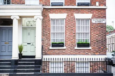 a brick house with a blue door and windows at Liverpool Georgian Town House Catharine St in Liverpool