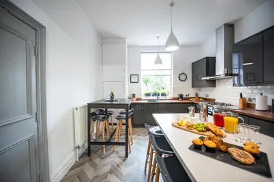 a kitchen with a table with food on it at Liverpool Georgian Town House Catharine St in Liverpool