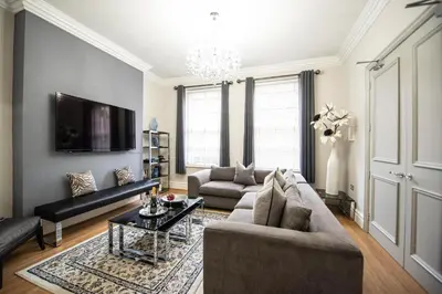 a living room with a couch and a table at Liverpool Georgian Town House Catharine St in Liverpool
