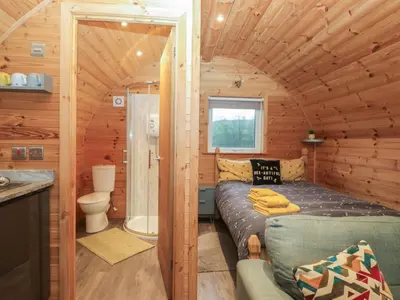 a small room with a bed in a tiny house at Oak in Ulverston