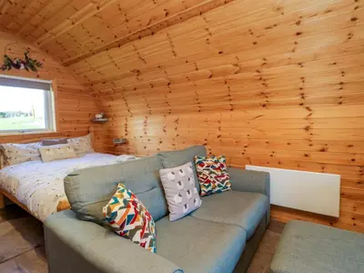 a living room with a couch and a bed at Cherry in Ulverston