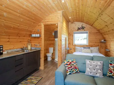 a room with a bed and a couch in a cabin at Cherry in Ulverston