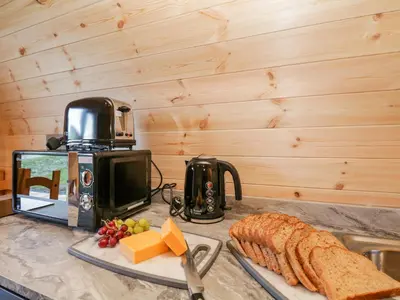 a counter top with bread and cheese and a toaster at Cherry in Ulverston