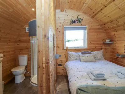 a bedroom with a bed in a wooden cabin at Cherry in Ulverston