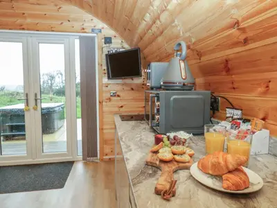 a table with a plate of bread and drinks in a cabin at Willow in Ulverston