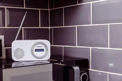 a small white radio sitting on top of a counter at Willow Chalet near Cartmel & Lake Windermere in Flookburgh