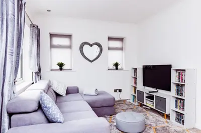 a living room with a couch and a tv at Willow Chalet near Cartmel & Lake Windermere in Flookburgh