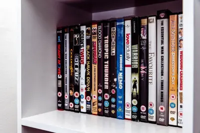 a row of dvds sitting on a shelf at Willow Chalet near Cartmel & Lake Windermere in Flookburgh