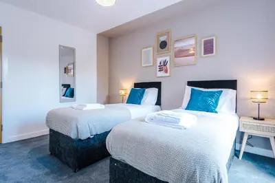 two beds in a room with blue and white at Formby Village Apartments By Greenstay Serviced Accommodation - Perfect For SHORT & LONG STAYS - Couples, Friends, Families & Business Travellers All Welcome - Dog Friendly - 7 in Formby