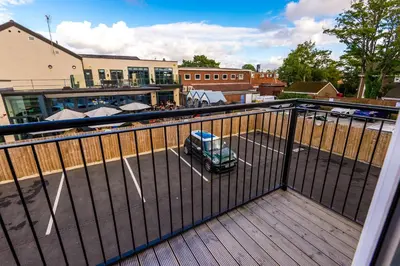 a small car parked in a parking lot on a balcony at Formby Village Apartments By Greenstay Serviced Accommodation - Perfect For SHORT & LONG STAYS - Couples, Friends, Families & Business Travellers All Welcome - Dog Friendly - 7 in Formby