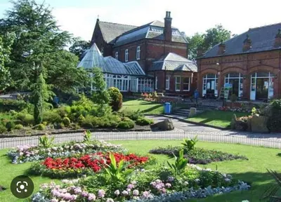 a large house with a garden in front of it at The Hideaway Southport in Southport