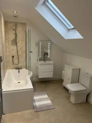 a bathroom with a sink and a shower and a toilet at The Hideaway Southport in Southport