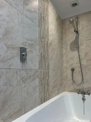 a bathroom with a shower and a bath tub at The Hideaway Southport in Southport