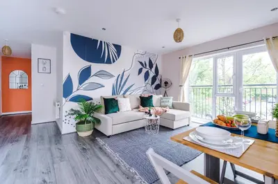 a living room with a couch and a table at Formby Village Apartments By Greenstay Serviced Accommodation - A Luxury 2 Bed Apt - Perfect for Couples, Friends, Families & Business Travellers - FREE Parking - Dog Friendly - Fast Wi-Fi - 6 in Formby