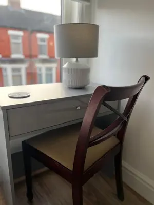a desk with a chair and a lamp on it at 2025 Award Winner Liverpool Ivy House - 4 Bedrooms in Liverpool