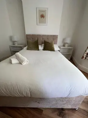 a bedroom with a large white bed with two night stands at 2025 Award Winner Liverpool Ivy House - 4 Bedrooms in Liverpool
