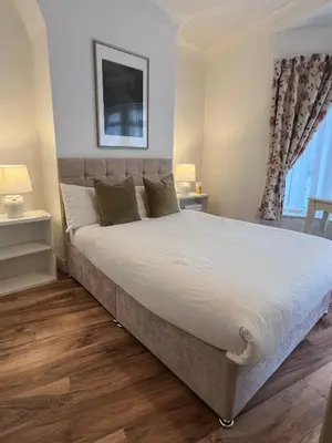a bedroom with a large bed and a window at 2025 Award Winner Liverpool Ivy House - 4 Bedrooms in Liverpool