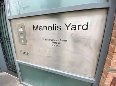 a sign for a manolis yard on the side of a building at Liverpool One Beautifully Presented 2 Bedroom Apartment in Liverpool