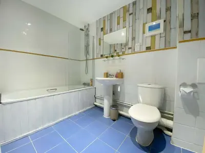 a bathroom with a toilet and a sink and a tub at Liverpool One Beautifully Presented 2 Bedroom Apartment in Liverpool
