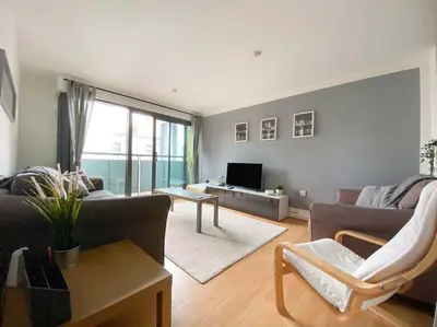 a living room with a couch and a tv at Liverpool One Beautifully Presented 2 Bedroom Apartment in Liverpool