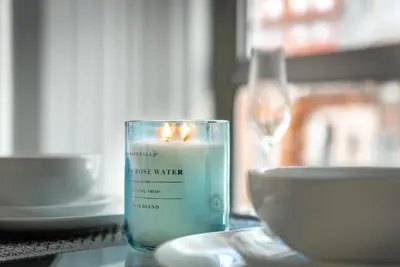 a candle sitting on a table next to a bowl at Brand New Stunning City Centre Open Plan 1Bed in Liverpool