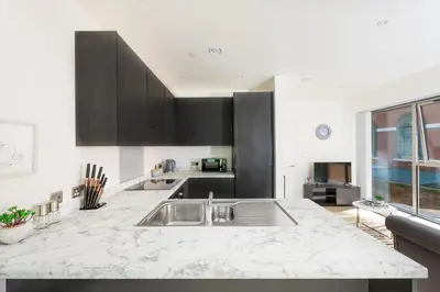 a kitchen with a sink and a counter top at Brand New Stunning City Centre Open Plan 1Bed in Liverpool