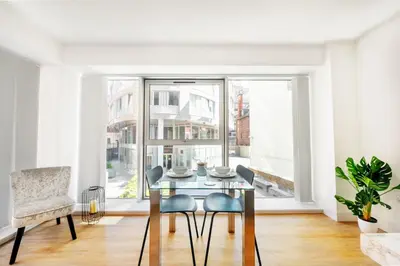 a dining room with a table and chairs and a window at Brand New Stunning City Centre Open Plan 1Bed in Liverpool