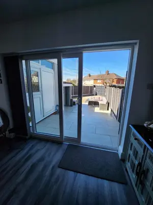an empty living room with a large sliding glass door at Delightful newly renovated 3-bed house with garden beach hut in Blackpool
