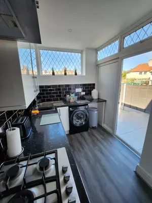 a kitchen with a stove and a stove top oven at Delightful newly renovated 3-bed house with garden beach hut in Blackpool