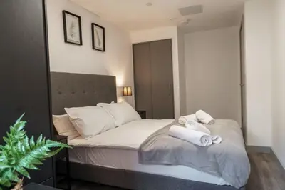 a bedroom with a bed with towels on it at Contemporary 1 Bed Apartment in Liverpool Centre in Liverpool