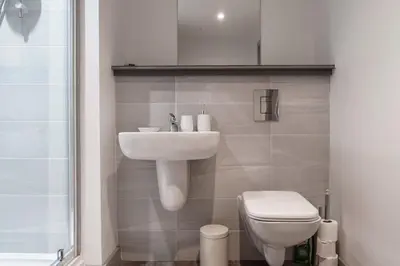 a bathroom with a sink and a toilet at Contemporary 1 Bed Apartment in Liverpool Centre in Liverpool