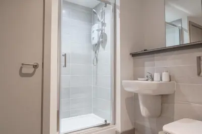 a bathroom with a shower and a toilet and a sink at Contemporary 1 Bed Apartment in Liverpool Centre in Liverpool
