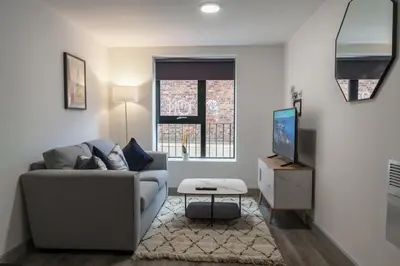 a living room with a couch and a tv at Contemporary 1 Bed Apartment in Liverpool Centre in Liverpool