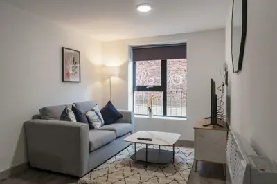 a living room with a couch and a tv at Contemporary 1 Bed Apartment in Liverpool Centre in Liverpool