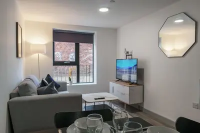 a living room with a couch and a tv at Contemporary 1 Bed Apartment in Liverpool Centre in Liverpool