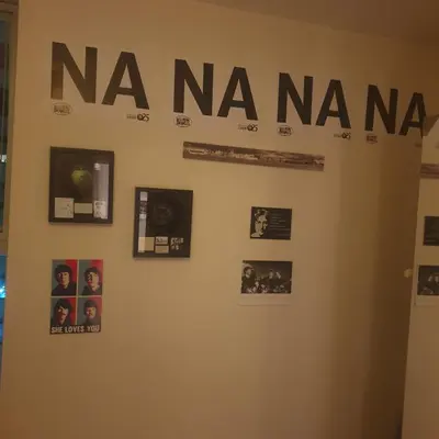 a wall with a naya sign on a wall with pictures at Luxury Apartment Best location in Liverpool city center in Liverpool