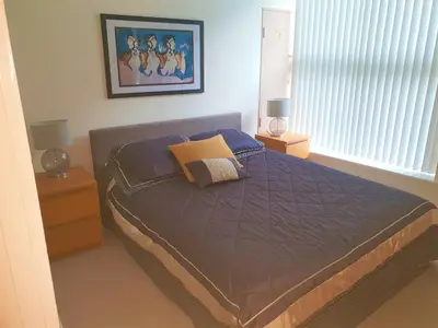 a bedroom with a bed with two night stands and two lamps at Luxury Apartment Best location in Liverpool city center in Liverpool